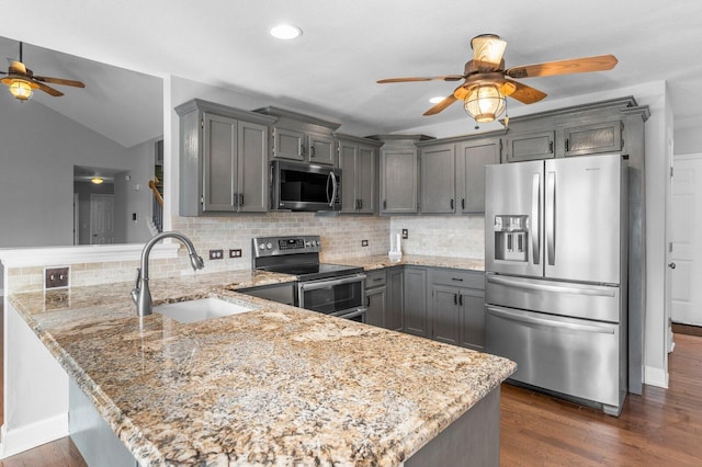 204 Lake Haven Dr, Soddy Daisy, TN 37379 - kitchen with stainless steel appliances, ceiling fan, a sink, a peninsula, and light stone countertops