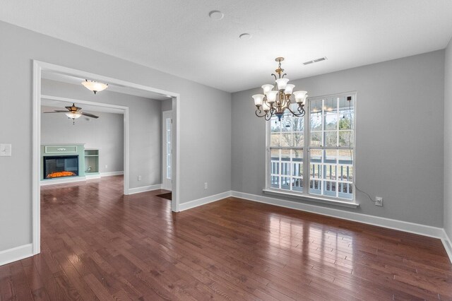 204 Lake Haven Dr, Soddy Daisy, TN 37379 - unfurnished dining area with ceiling fan, wood finished floors, a glass covered fireplace, and a chandelier