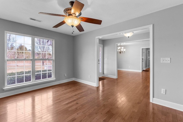 204 Lake Haven Dr, Soddy Daisy, TN 37379 - empty room with a chandelier, baseboards, wood finished floors, and ceiling fan