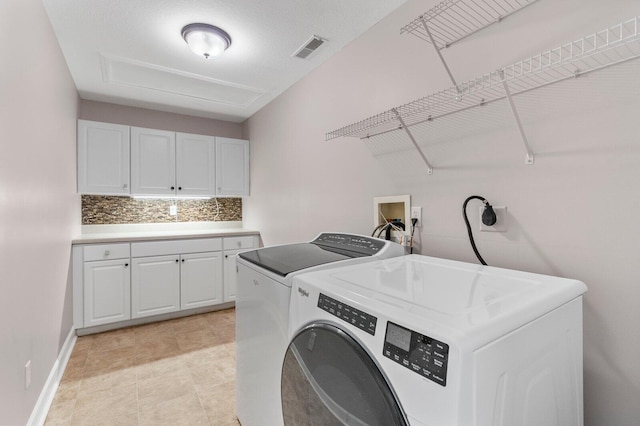 204 Lake Haven Dr, Soddy Daisy, TN 37379 - clothes washing area featuring washer and clothes dryer and cabinet space
