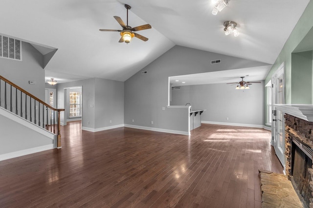 204 Lake Haven Dr, Soddy Daisy, TN 37379 - unfurnished living room with ceiling fan, a fireplace, vaulted ceiling, wood finished floors, and stairs