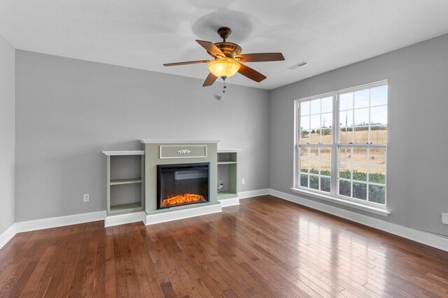 204 Lake Haven Dr, Soddy Daisy, TN 37379 - unfurnished living room featuring wood-type flooring, baseboards, a glass covered fireplace, and ceiling fan