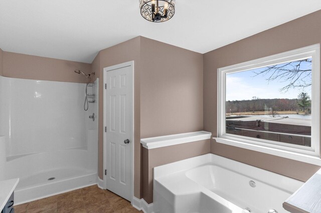 204 Lake Haven Dr, Soddy Daisy, TN 37379 - bathroom featuring a bath, a shower, a chandelier, tile patterned flooring, and baseboards