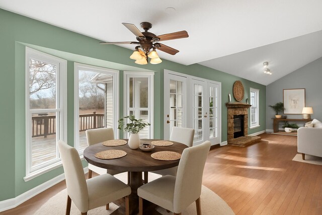 204 Lake Haven Dr, Soddy Daisy, TN 37379 - dining area with baseboards, hardwood / wood-style floors, a ceiling fan, a fireplace, and vaulted ceiling