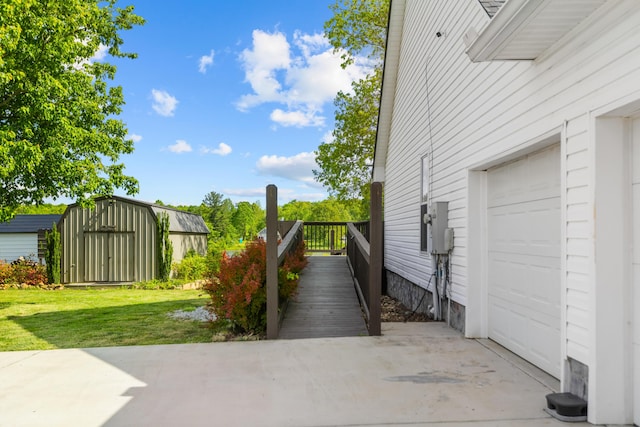 204 Lake Haven Dr, Soddy Daisy, TN 37379 - view of side of home featuring a garage, a lawn, and a storage shed