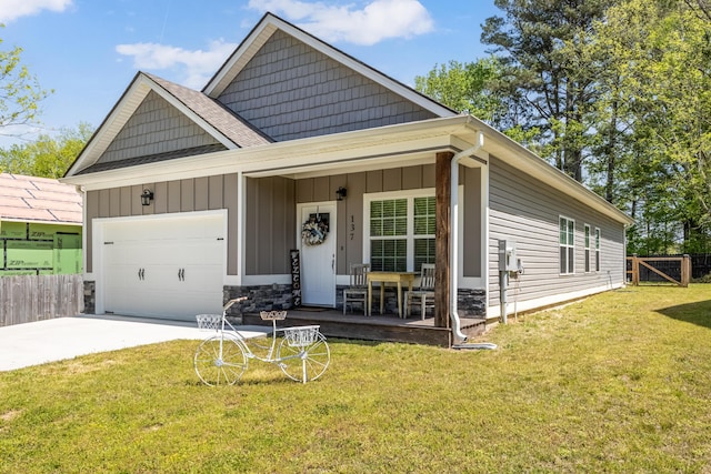 137 Elm Ave, Ringgold, GA 30736 - view of front of home featuring a garage, fence, concrete driveway, board and batten siding, and a front yard