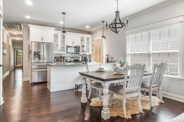 137 Elm Ave, Ringgold, GA 30736 - dining area with baseboards, visible vents, crown molding, dark wood-style flooring, and a notable chandelier