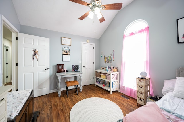bedroom with dark wood finished floors, multiple windows, lofted ceiling, and visible vents