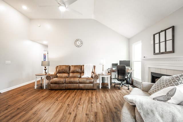 living area with wood finished floors, baseboards, lofted ceiling, and ceiling fan