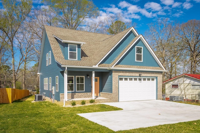 craftsman-style home featuring fence, central air condition unit, driveway, covered porch, and a front yard