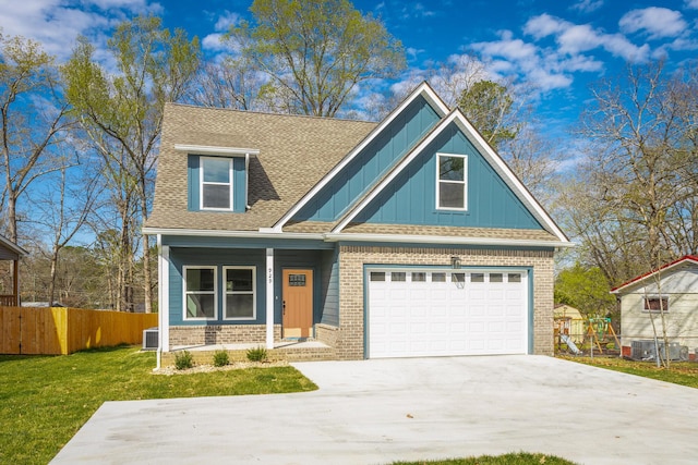 craftsman-style house featuring concrete driveway, board and batten siding, fence, a porch, and brick siding