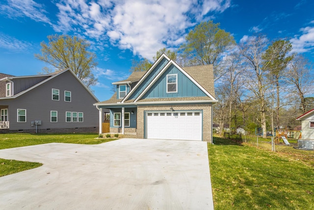 craftsman house with board and batten siding, driveway, a front yard, and brick siding