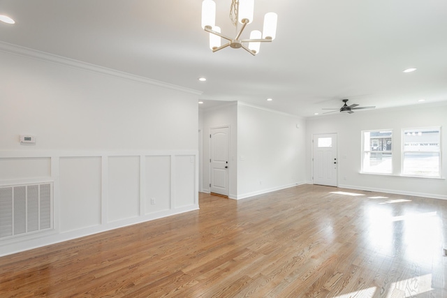 unfurnished living room featuring recessed lighting, visible vents, ornamental molding, light wood-type flooring, and ceiling fan with notable chandelier