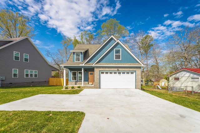 view of front of home with a front lawn, driveway, board and batten siding, fence, and brick siding