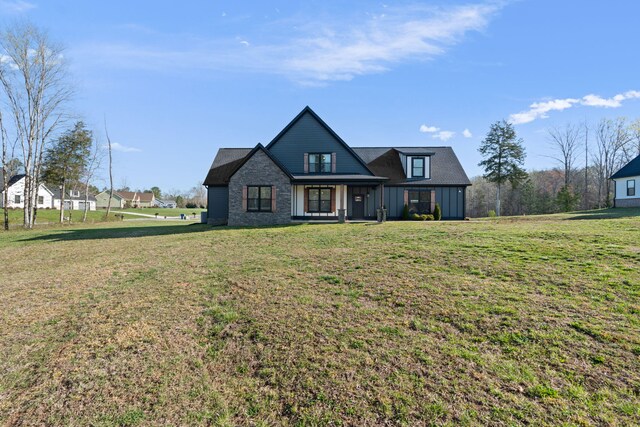 view of front of house with a front lawn and board and batten siding