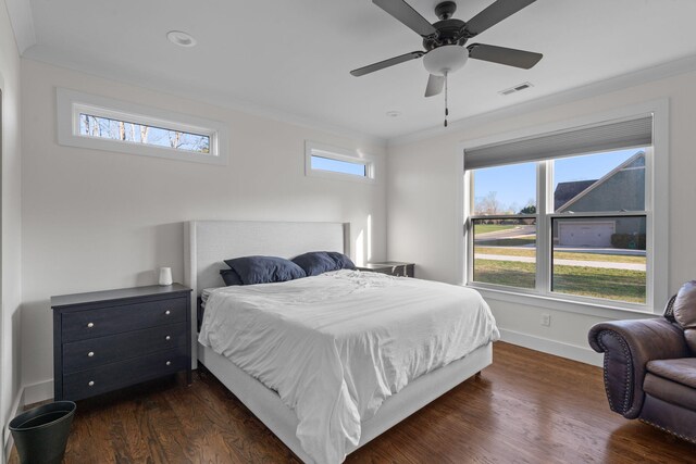 bedroom featuring multiple windows, visible vents, and dark wood-style flooring