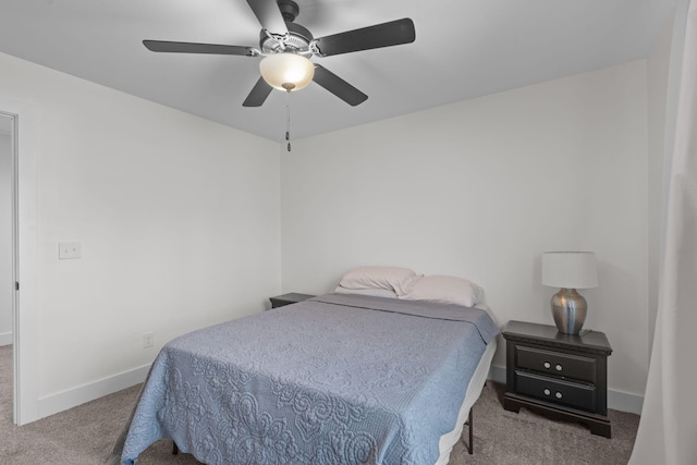 carpeted bedroom featuring a ceiling fan and baseboards