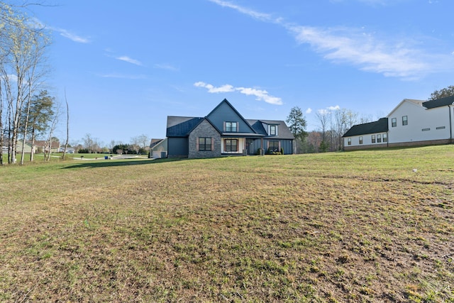 modern farmhouse style home with a front lawn