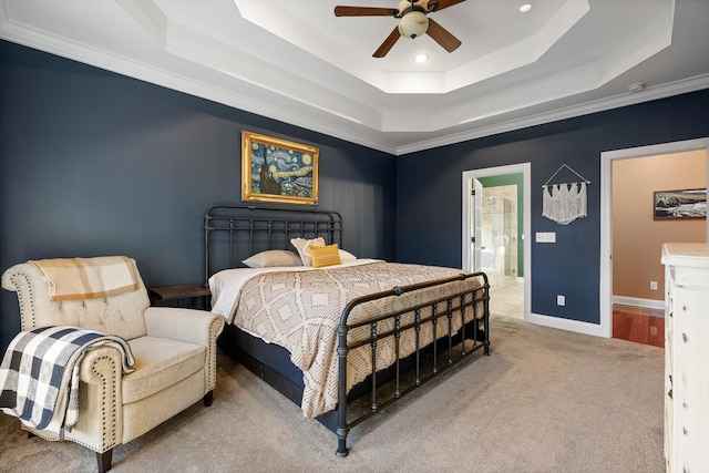 carpeted bedroom with a tray ceiling, baseboards, recessed lighting, and a ceiling fan