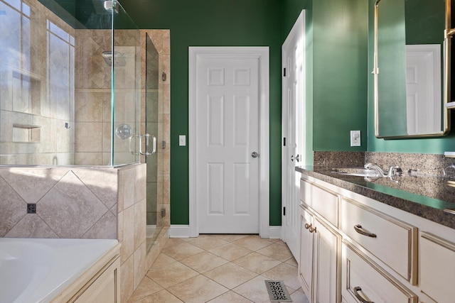 bathroom with a stall shower, tile patterned floors, vanity, a bath, and visible vents