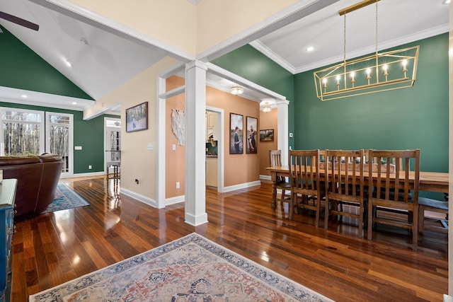 dining area featuring ornate columns, hardwood / wood-style floors, ornamental molding, high vaulted ceiling, and baseboards
