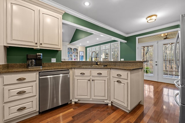 kitchen featuring crown molding, dark wood-type flooring, a sink, french doors, and stainless steel dishwasher