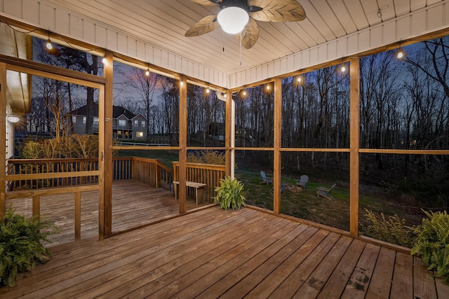 unfurnished sunroom with a ceiling fan