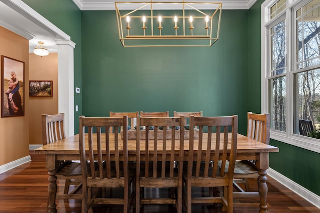 dining area featuring ornamental molding, baseboards, and wood finished floors