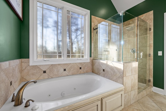 bathroom featuring a tub with jets, tile patterned floors, a stall shower, and a healthy amount of sunlight