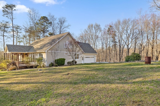 view of side of property with a deck, a garage, and a yard