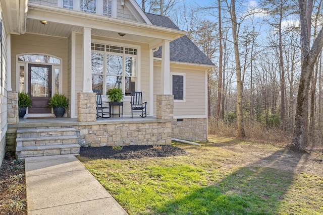 doorway to property with covered porch and roof with shingles