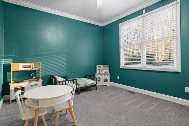 interior space with baseboards, carpet floors, ornamental molding, and visible vents