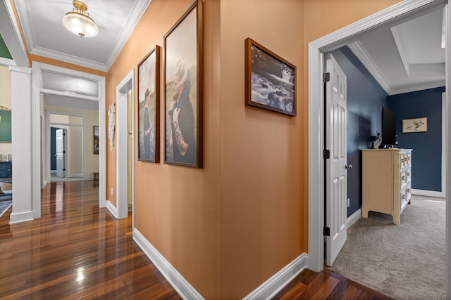 corridor featuring ornamental molding, baseboards, and dark wood finished floors