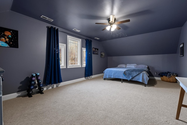 carpeted bedroom with baseboards, visible vents, and vaulted ceiling