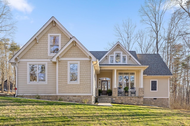 craftsman inspired home featuring a front yard, covered porch, and roof with shingles