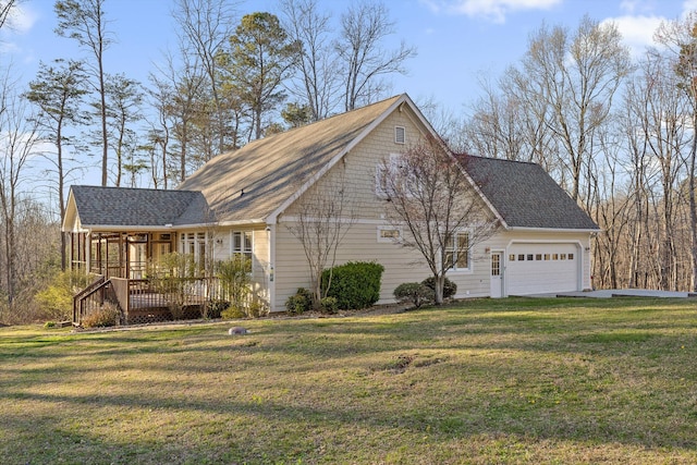 view of home's exterior with roof with shingles, a wooden deck, an attached garage, and a yard
