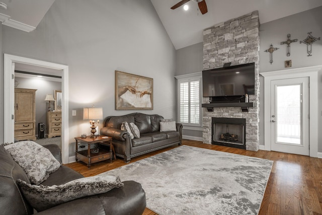 8975 Silver Maple Dr, Ooltewah, TN 37363 - living room with high vaulted ceiling, wood finished floors, a stone fireplace, baseboards, and ceiling fan