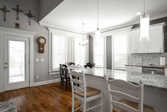 8975 Silver Maple Dr, Ooltewah, TN 37363 - dining area featuring crown molding, baseboards, a chandelier, and dark wood-type flooring