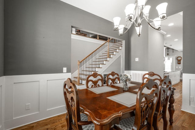 8975 Silver Maple Dr, Ooltewah, TN 37363 - dining room with stairs, visible vents, light wood-style flooring, and wainscoting