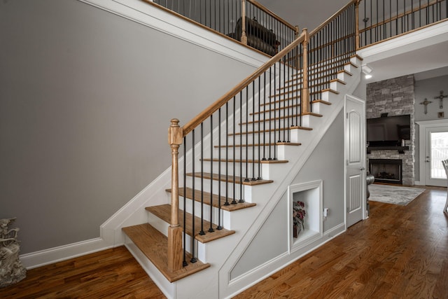 8975 Silver Maple Dr, Ooltewah, TN 37363 - stairs with a high ceiling, baseboards, a fireplace, and wood finished floors