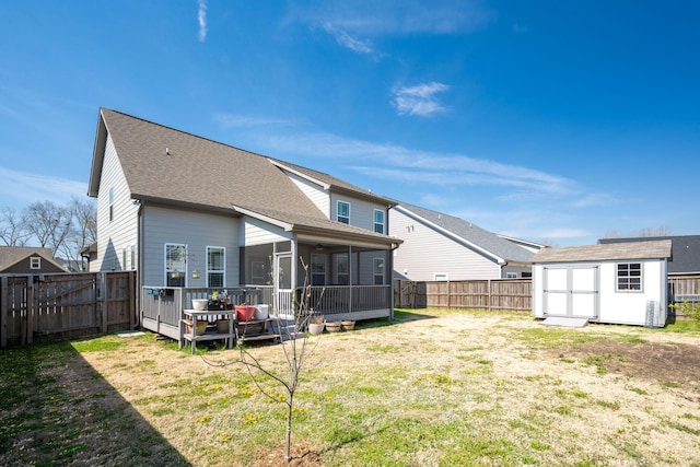 8975 Silver Maple Dr, Ooltewah, TN 37363 - back of property with a sunroom, a fenced backyard, a lawn, an outdoor structure, and a shed