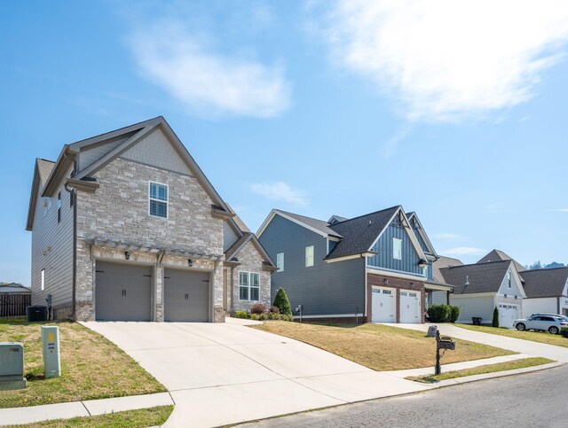 8975 Silver Maple Dr, Ooltewah, TN 37363 - craftsman-style house featuring stone siding, a garage, central AC, and concrete driveway