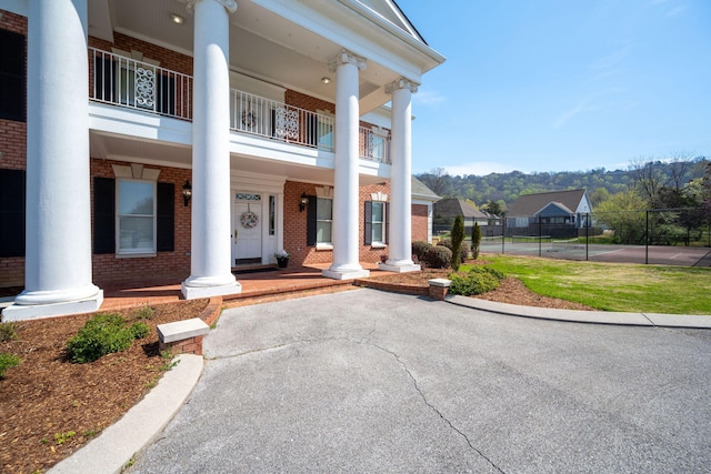 8975 Silver Maple Dr, Ooltewah, TN 37363 - exterior space featuring covered porch, brick siding, and a balcony