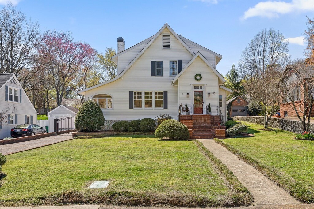 140 Ridgeside Rd, Chattanooga, TN 37411 - english style home featuring fence, a chimney, a front yard, and a garage
