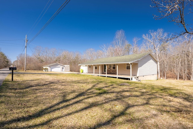 view of front of home with a front lawn, crawl space, an outbuilding, and a porch