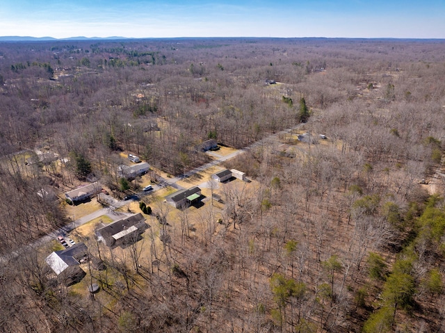 birds eye view of property featuring a view of trees