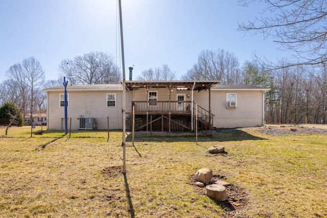 back of house featuring stairs, central AC unit, a wooden deck, and a yard