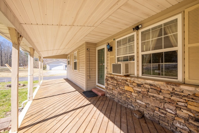 wooden deck with cooling unit and a porch