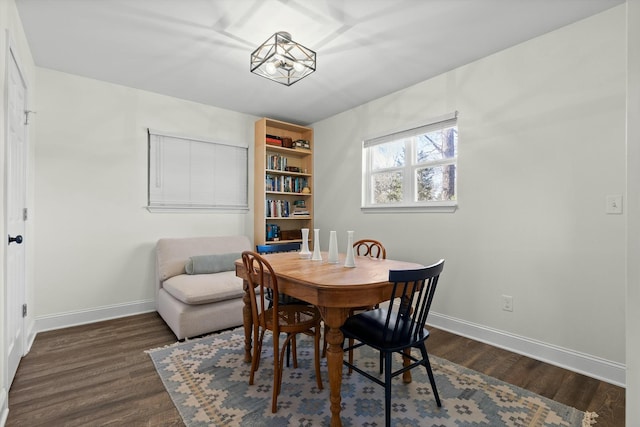 dining room featuring baseboards and dark wood-style floors