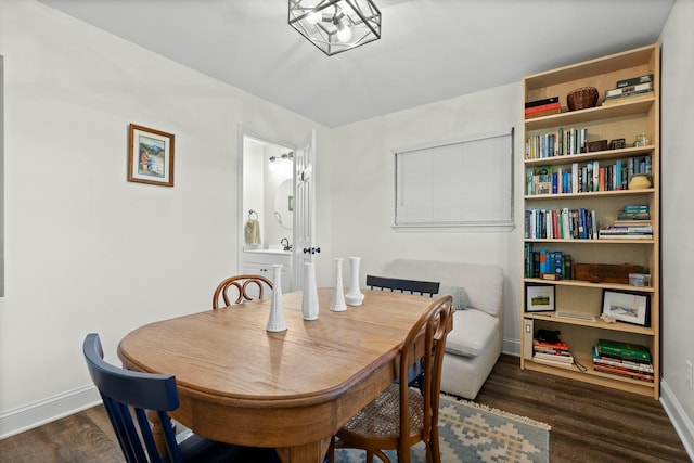 dining space featuring baseboards and wood finished floors